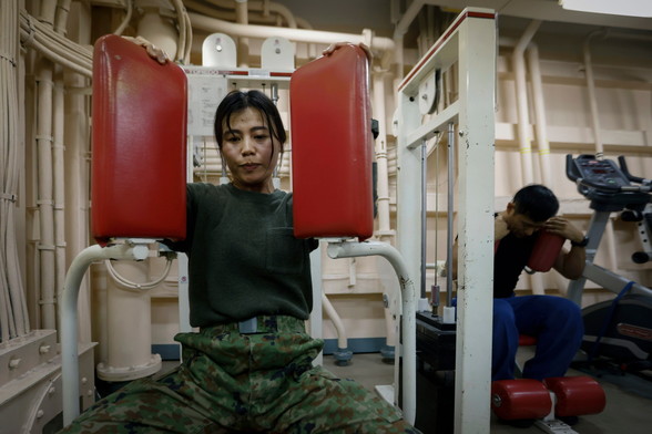 Hikari Maruyama takes part in physical training at a gym space inside the amphibious transport ship JS Osumi (LST-4001) in waters close to Okinawa, Japan November 14, 2023. REUTERS/Issei Kato
