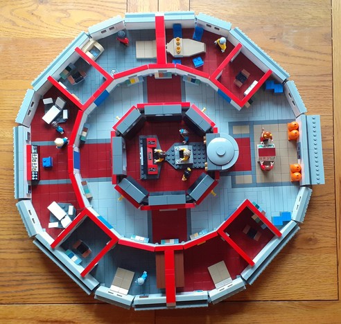 A closer look at the #SaucerSection. In the centre we have the #MainBridge surrounded by a #CentralCorridor which then branches out to 8 rooms, with #Sickbay at the front, and the #ImpulseDrive to the rear