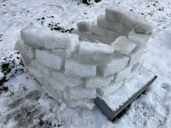 The outside of a very tiny roof, less snow igloo. It could fit two adults sitting inside.