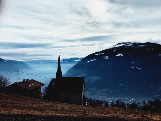 A tiny church of a mountain village with an open view