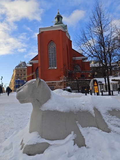 snow covered lion statue outside St Jacobs church, Stockholm