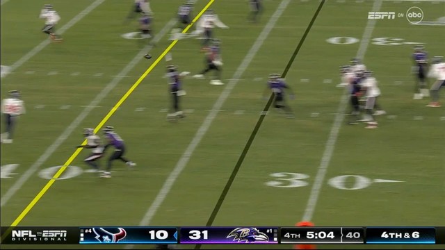 American football game in progress with the score displaying one team leading 31-10 in the 4th quarter. Players are dispersed on the field with a blurry ball in motion.