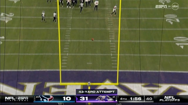 American football field during a game with a football in midair following a 43-yard field goal attempt, scoreboard showing the home team leading 31-10 with 1:56 left in the fourth quarter.