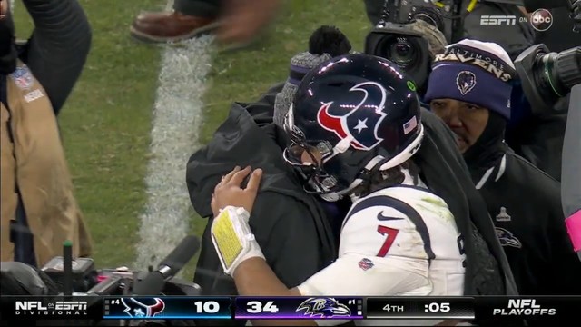Lamar Jackson and CJ Stroud hugging it out on the field after a hard fought good game, with the scoreboard showing a 34-10 game in the final moments.