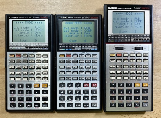 Three Casio scientific calculators side by side on a wooden surface.