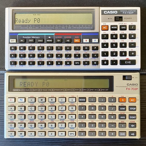 Two vintage Casio programmable calculators, models FX-730P and FX-702P, displayed with their screens turned on.