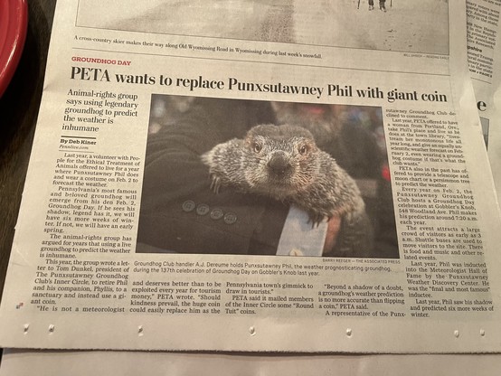newspaper article with headline: “PETA wants to replace Punxsutawney Phil with giant coin”