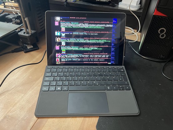 picture of a surface go tablet with typecover on a table.

a fullscreen version of DOStodon is running showing the home timeline of the testuser