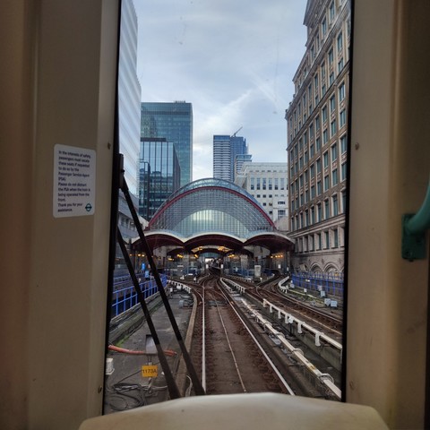 A view along the rails from the front seat of a carriage of the London Docklands Railway emerging the Canary Wharf station
