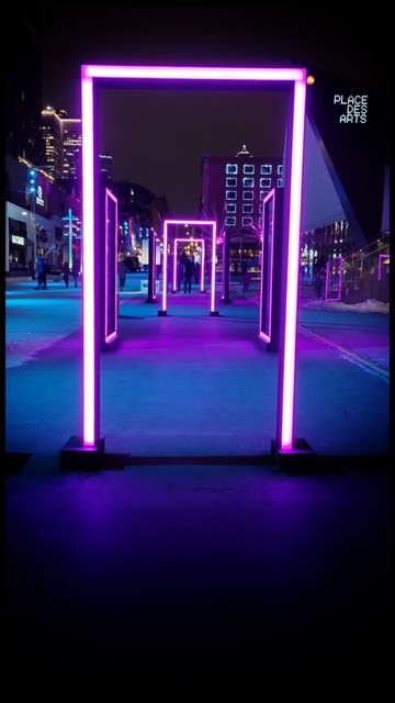 Neon art installation on Place des Arts, purple in the shape of a series of gateways.
