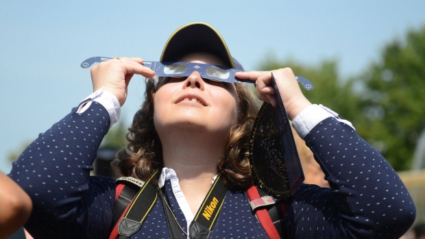 A lady watching a solar eclipse