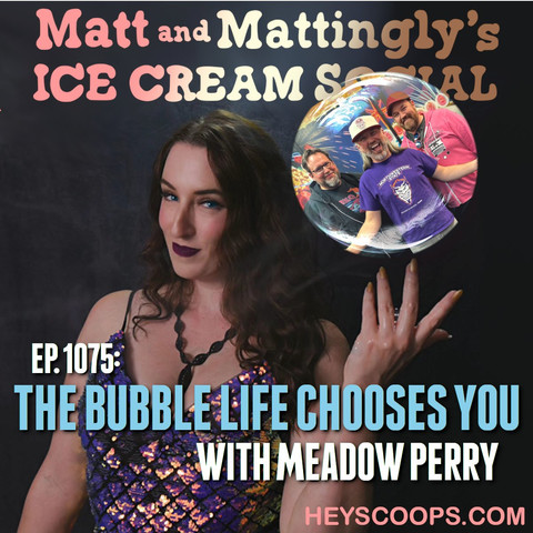 Promotional image for Matt and Mattingly's Ice Cream Social Podcast, Episode 1075 titled 'The Bubble Life Chooses You' featuring Meadow Perry. In the foreground, Meadow Perry is posing with a playful and confident expression, dressed in a sequined garment with a necklace, holding up a bubble with her fingers. In the bubble, three smiling men are depicted, presumably the hosts. The background is dark with the podcast's title in stylized lettering at the top and the website 'heyscoops.com' at the bottom.