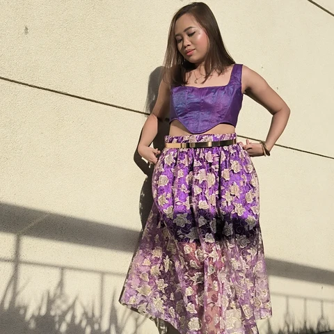 Completed outfit with a shimmery purple corset and a floral skirt with half the inner lining slashed from the skirt to give it a more balanced effect