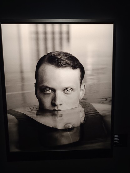 Very captivating eyes - a man is mostly under water but his head is above the water level 