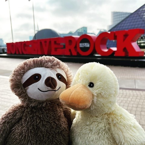 duck and sloth in front of the rock n roll hall of fame