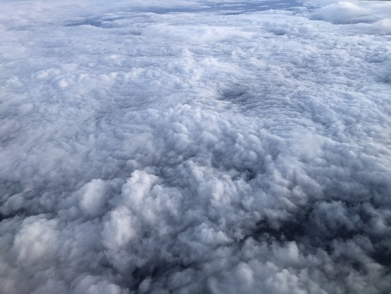 Swirls and puffs of lower level clouds, photo from an airplane window