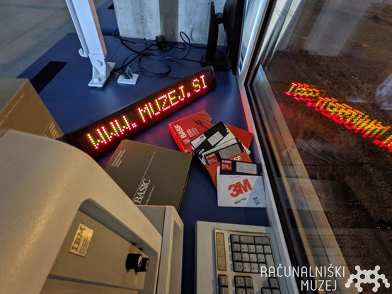 our storefront with LED display, caption 'www. muzej. si' on the display