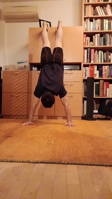 I'm doing a wall-assisted handstand and I complete a push-up in this short video. Posterior view, as my head is to the wall (actually, it's a cabinet, but same difference). More on YouTube at @MeFitYouFit. (I lost 50 pounds in 2020 and got fitter than I've ever been before.)