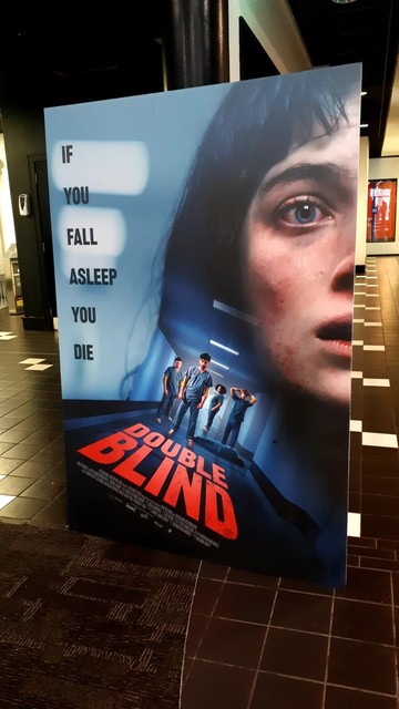 Film poster for double blind in  cinema foyer with the tagline If you fall asleep you die