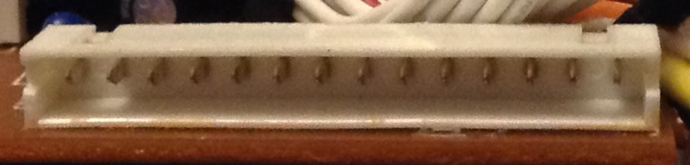 Close up photo of a 14-pin JST-XH like shrouded set of pins showing them as flat rather than square in profile.