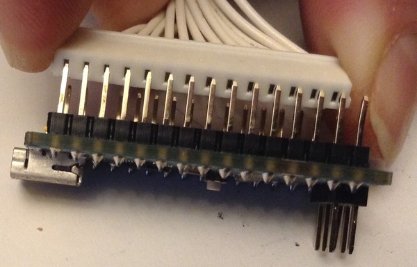 Photo of the JST XH like plug showing the hole spacing is just shy of fully lining up with the pin headers on an Arduino nano supporting the idea that they are 2.50mm rather than 2.54mm.
