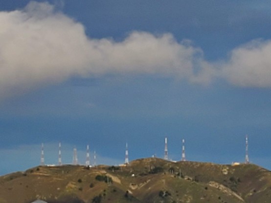 Small puffy cloud dragons hanging around above the locate "mountain" (really more like a big hill.)