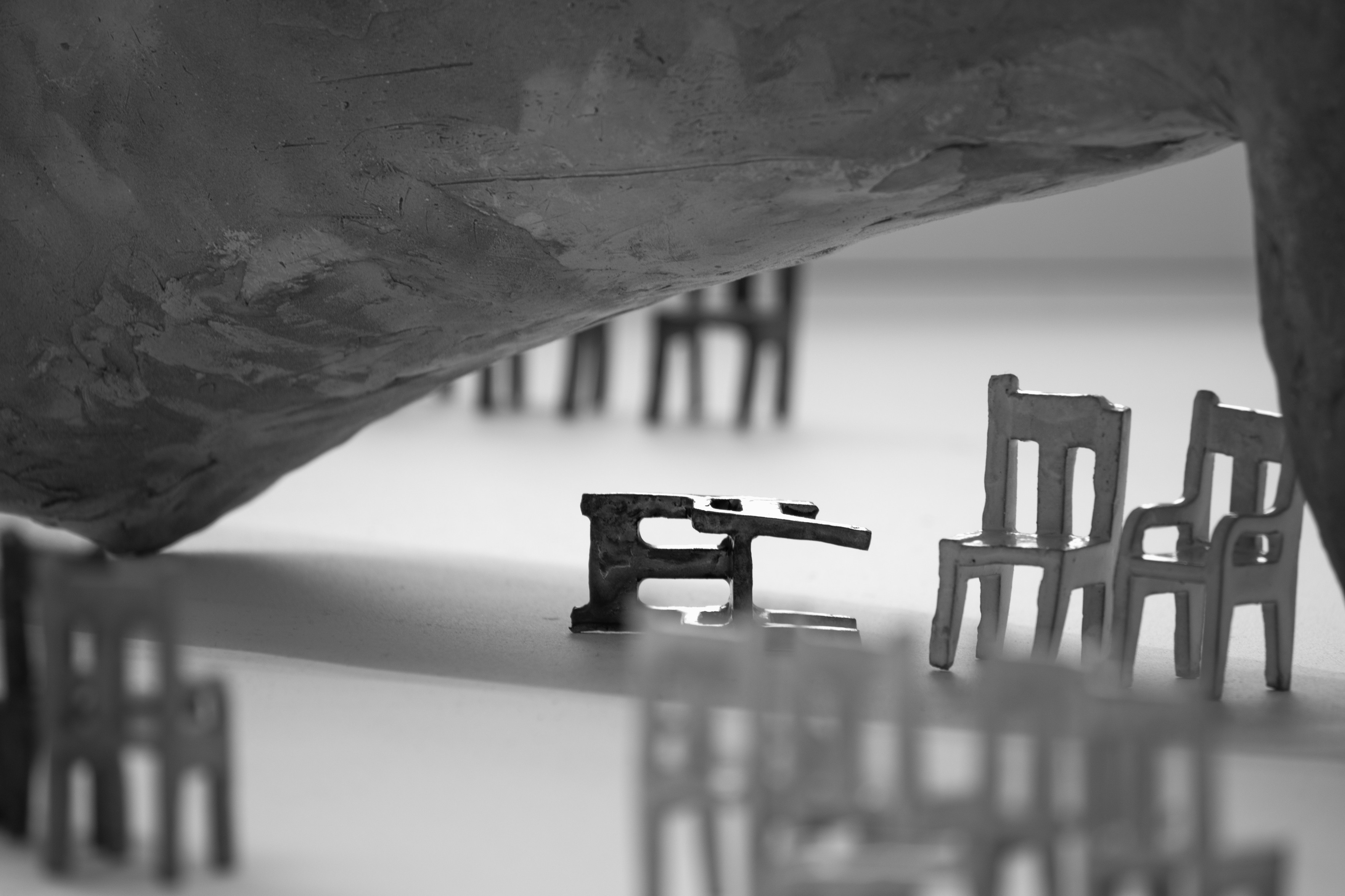 fallen chair under the leg sculpture