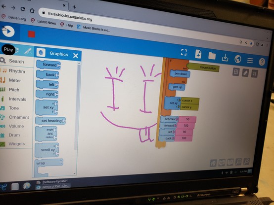 A picture of a smiley face, drawn on a screen. Visual code is visible in the image, which indicates a script of "when mouse button is down, then pen down; else pen up; follow cursor forever".