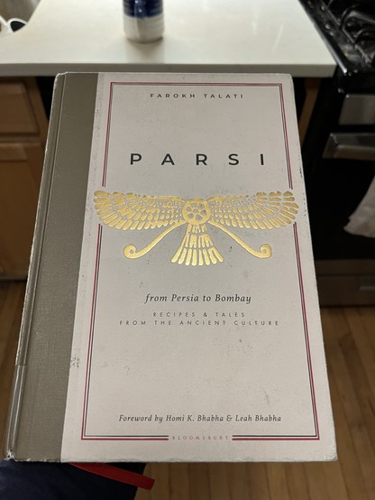 A book titled "PARSI" with a subtitle "from Persia to Bombay RECIPES & TALES FROM THE ANCIENT CULTURE" by Farokh Talati with a foreword by Homi K. Bhabha & Leah Bhabha.