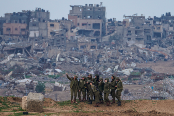 Israeli soldiers maintaining their humanity by taking a selfie, smiling, with all the destruction they are causing in Gaza in the background. So very humane for fascists.