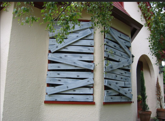 A house with boarded up windows is shown. It's an analogy. 