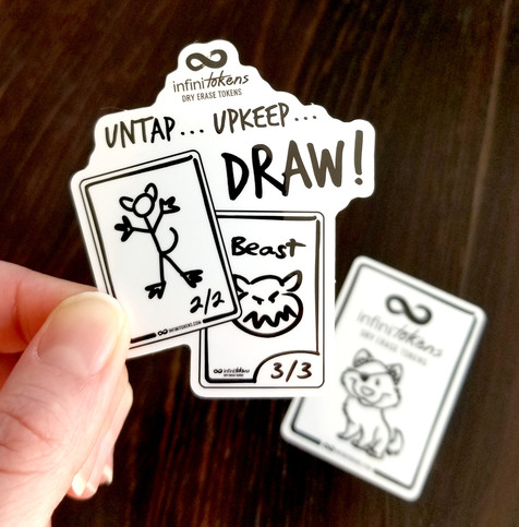 A sticker with InfiniTokens on it that says "Untap, Upkeep, DRAW!" with a pirate wolf sticker in the background.
