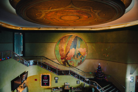 Photo of the Inwood Theater's gorgeous lobby with its wall & ceiling murals, vending area, and grand staircase overlooking the lobby