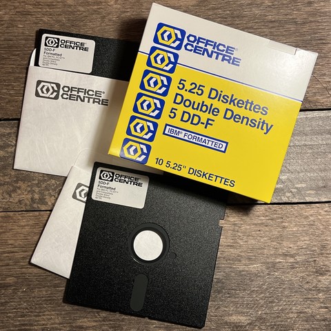 A box of floppy disks from Office Centre with a late 70s/early 80s aesthetic logo of overlapping hexagon O and C in yellow, white, and blue. 