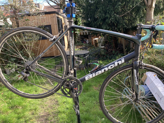 Filthy Bianchi road bike on a bike stand