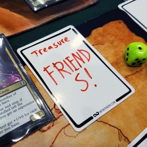 An InfiniToken dry erase treasure token that says "Friends!"