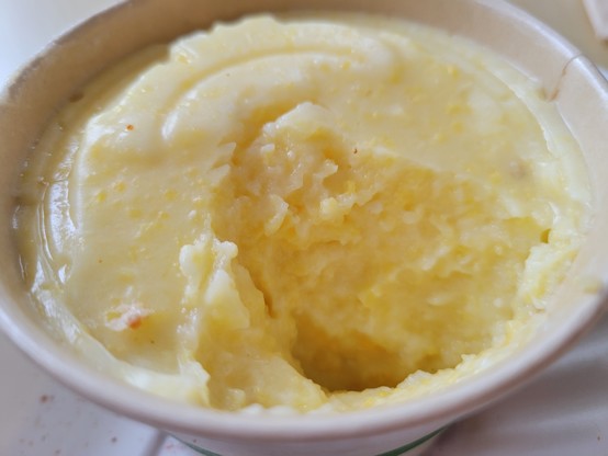 Grits, partially eaten, in a white paperboard cup