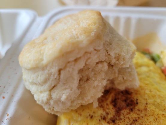 Cream biscuit resting on the succotash omelet