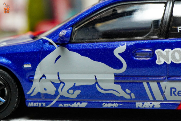 A close-up shot of Honda Civic Type-R EK9 No Good Racing Red Bull Livery by INNO64 in 1:64 scale with 1:64 figure on area 164