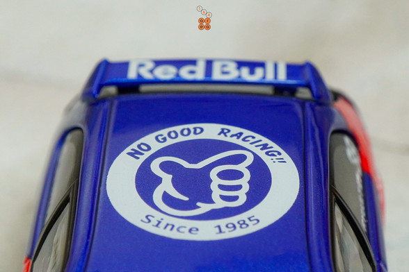 A close-up shot of Honda Civic Type-R EK9 No Good Racing Red Bull Livery by INNO64 in 1:64 scale with 1:64 figure on area 164