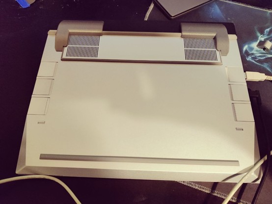 Framework 16 Laptop on its back with two edge protectors installed