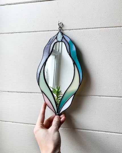 Wall mirror in the shape of a vulva.
