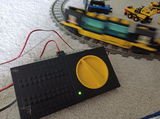 LEGO rail connection cable with renewed wiring connected to tracks, train, and control.