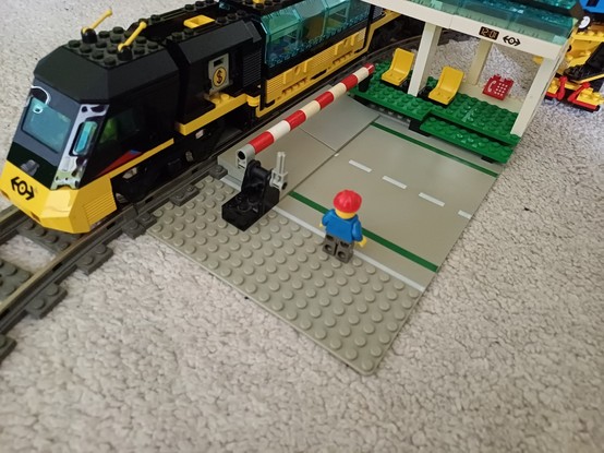 A LEGO level crossing with 9V tracks