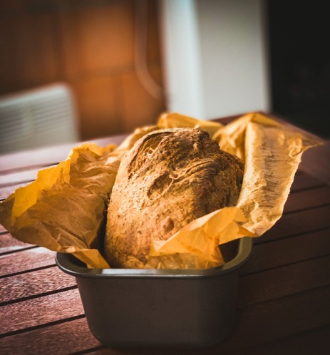 A tin loaf is standing on table