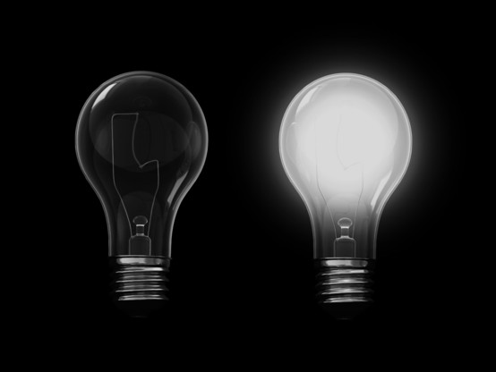Free clip art, showing two lightbulbs. One is off and dark, the other lightbulb is lit.