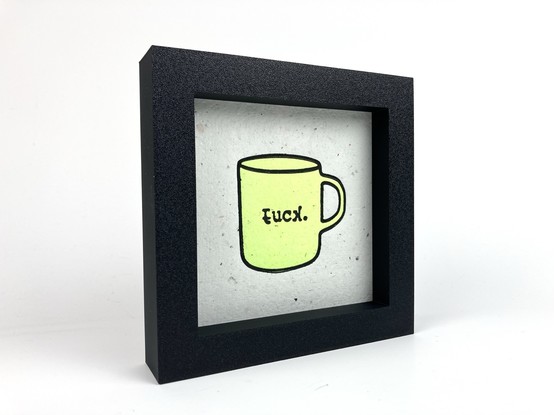 A relief print of a mug that kind of says “fuck.”.