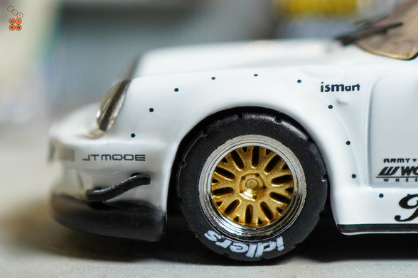 A close-up shot of Porsche RWB 930 Kamizawa by Tarmac Works in 1:64 scale with 1:64 figure on area 164