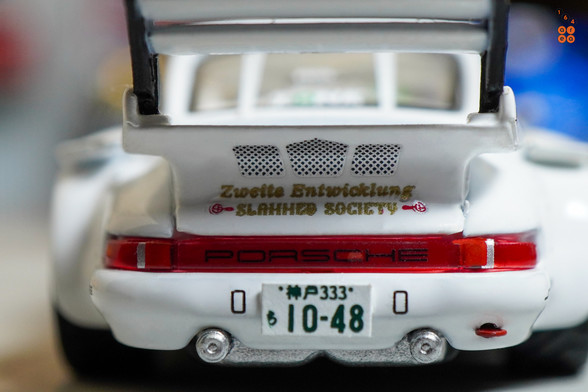 A close-up shot of Porsche RWB 930 Kamizawa by Tarmac Works in 1:64 scale with 1:64 figure on area 164