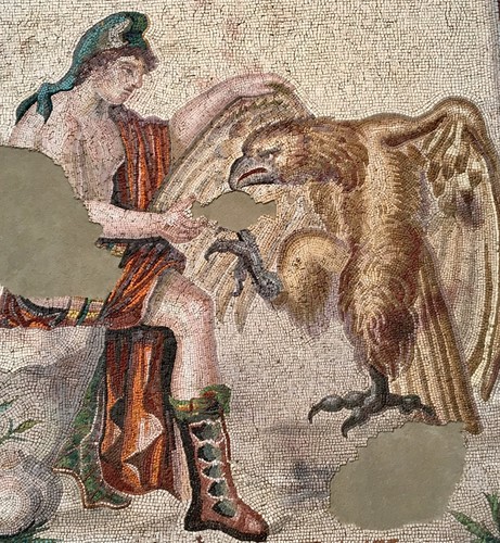 Roman mosaic of Zeus and Ganymede from the collections of the Met Museum in New York. Ganymede was abducted by Zeus (in the form of an eagle) to serve as a cupbearer in Olympus. The mosaic dates from the 2nd century CE.